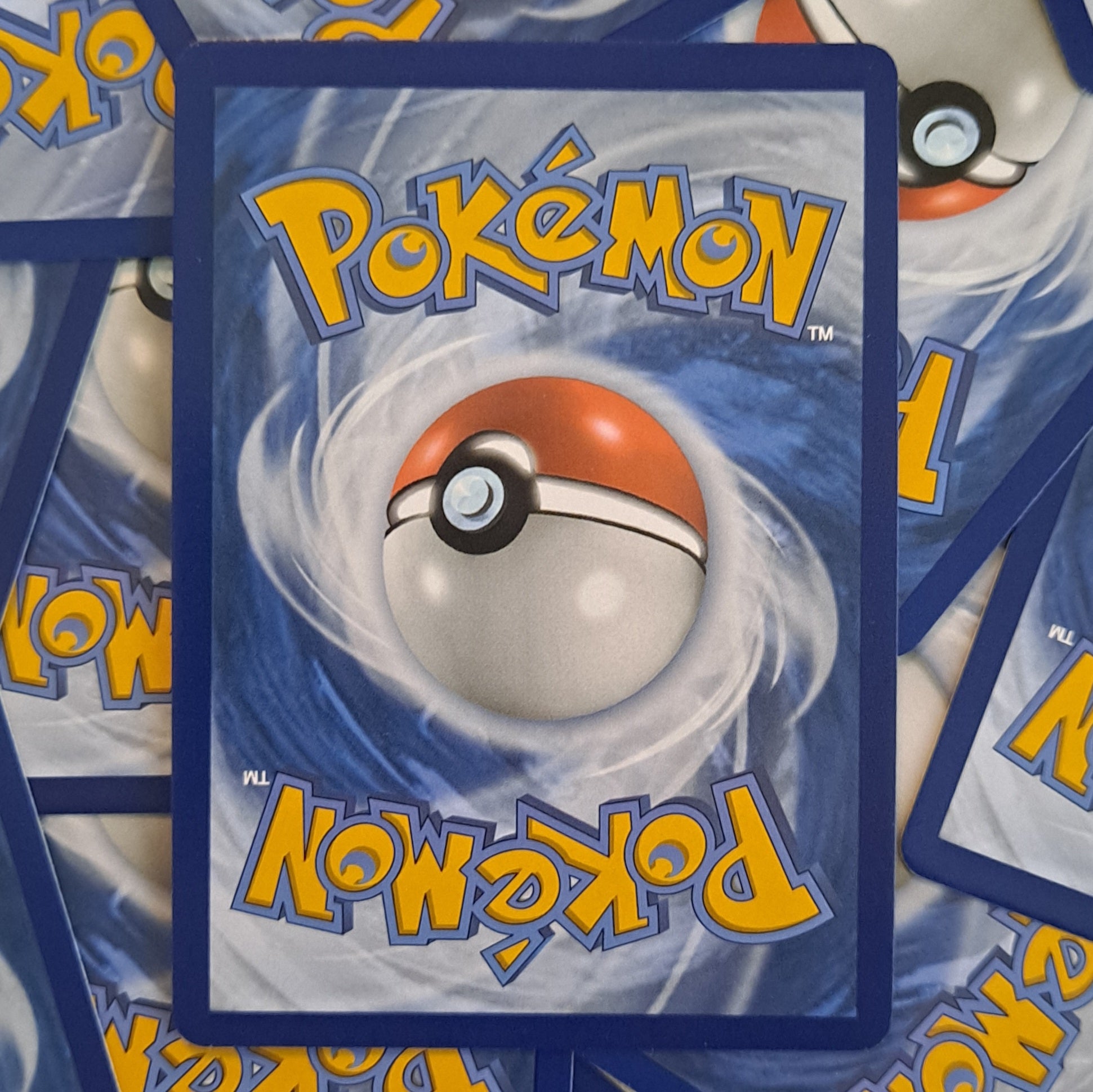 Pokémon trading cards with a central Poké Ball design